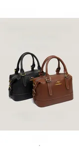 Detailed view of luxury Boston bags in black and brown pebbled leather with gold hardware