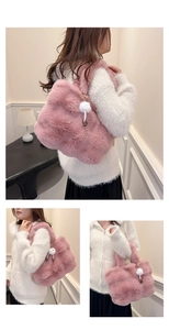 Detailed views of a pink faux fur bucket bag with a pompom chain charm and soft texture