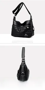 Close-up of black quilted leather shoulder bag with metallic kangaroo logo and zippers