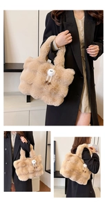 Macro detail of camel plush tote bag featuring soft faux fur and white pompom charm