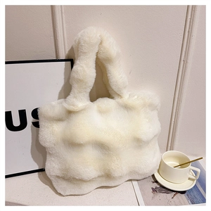 Close-up of a plush faux fur tote bag in creamy white with integrated soft handles