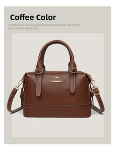 Detailed view of coffee brown Boston bag with textured leather and gold-tone kangaroo logo