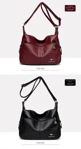 Detail of red and black crossbody bags with stone pattern texture and kangaroo logo
