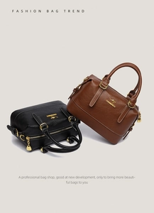 Detail of premium grain leather Boston bag with gold kangaroo logo and metal zippers