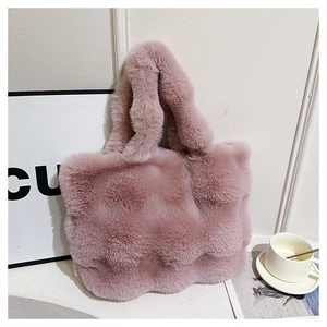 Detail of pink faux fur tote bag showing soft plush texture and wide top handle