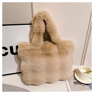 Close-up of soft fluffy cream plush handbag showing wavy cloud edge and furry texture