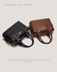Detail of Boston bags showing lychee grain leather, golden kangaroo logo, and handles