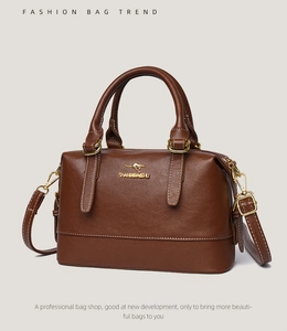 Detail of premium brown pebble leather Boston bag with gold-tone hardware and adjustable strap