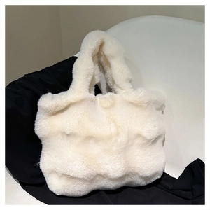 Detail of soft white faux fur tote bag showing plush texture and integrated handle