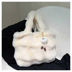 Detailed close-up showing soft white plush texture and cute pom-pom pendant on the bucket bag