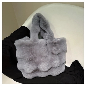 Detailed view of the soft grey faux fur bucket bag with a wavy texture for winter