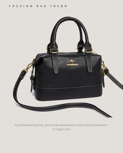 Detail of black pebbled leather Boston bag with golden kangaroo logo and hardware