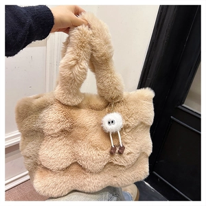 Close-up of fluffy plush tote bag with a cute white round monster doll charm