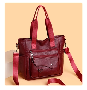 Detailed shot of burgundy PU tote bag with heart buckle and multiple functional zippers