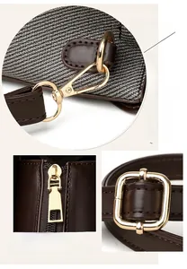 Detail of gold swivel hooks and metal zipper on brown leather and woven shoulder bag
