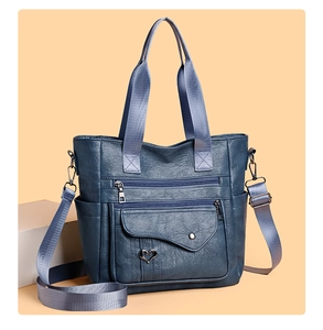 Detail of large navy blue PU leather tote bag with heart charm and multi-pocket design