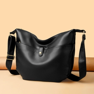 Black pebble leather tote bag for women with gold hardware and wide shoulder strap