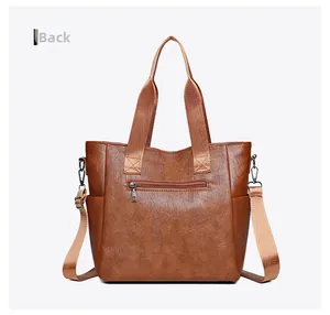 Rear view of brown PU leather tote bag showing back zipper pocket and side slots