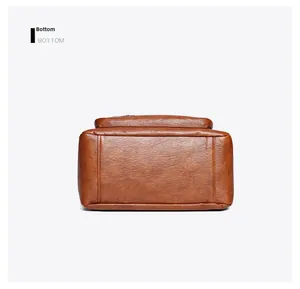 Detailed bottom view of brown faux leather tote bag with reinforced double stitching