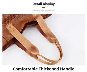 Detail of comfortable thickened handle with cross stitching on brown leather tote bag
