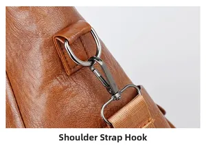 Detail view of the durable metal lobster clasp and D-ring on the brown leather tote bag