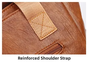 Close-up of reinforced shoulder strap stitching on brown lychee pattern leather tote bag