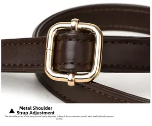 Detail of adjustable dark brown leather shoulder strap with golden metal buckle
