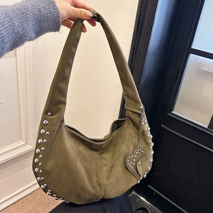 Vintage green suede hobo bag with silver studs and heart charm detail shown in hand