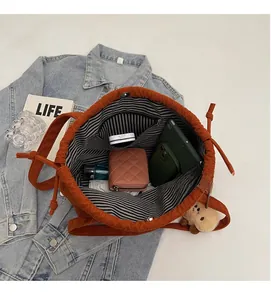 Detail view of corduroy tote bag interior with striped lining and organized daily essentials