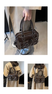 Detail of dark brown glossy handbag with functional exterior pockets and bow accents