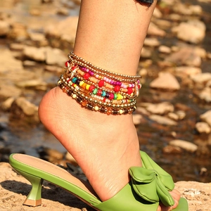 Detalle de conjunto de tobilleras bohemias con estrella de mar y cuentas de colores