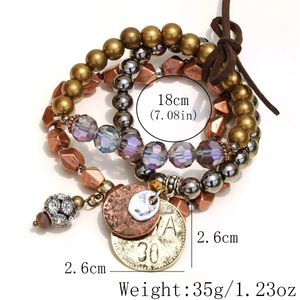 Detail of vintage crystal beaded bracelet set with metallic charms on white background