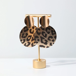 Fashion geometric earrings featuring layered golden metal discs and leopard print circles