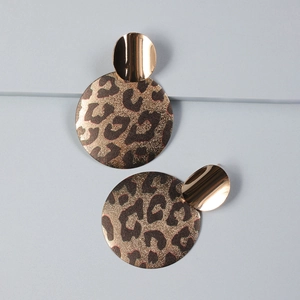 Detail view of bold geometric leopard print earrings with gold metallic oval accent