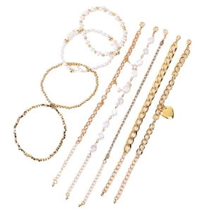 Ensemble de 9 bracelets dorés avec perles, strass et pendentif cœur sur fond blanc pur