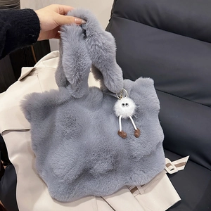 Gray plush faux fur tote bag for women with a cute monster charm for autumn and winter