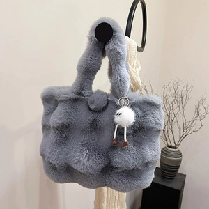 Faux fox fur tote bag in grey with fluffy wave texture and monster charm accessory