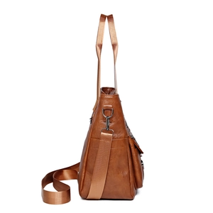 Brown retro PU leather tote bag with large capacity and side zipper on white background