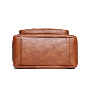 Bottom view of brown soft leather tote bag showing high-quality stitching and texture