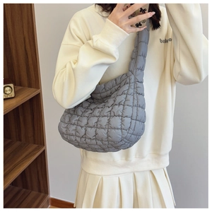 Quilted gray cloud puffy bag with padded texture shoulder strap on Asian model