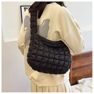 Close-up of black quilted cloud bag showing diamond stitch detail on nylon fabric