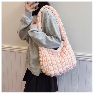 Side view of soft pink quilted cloud hobo bag showing its lightweight puff texture