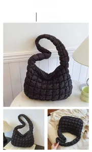 Detail of black quilted cloud shoulder bag showing soft texture and wide strap design
