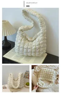 Close-up of off-white quilted cloud bag with puffy texture and soft fabric detail