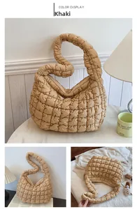 Close-up of khaki quilted puffy crossbody bag with cloud texture and zipper detail