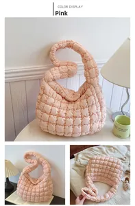 Detailed view of pink quilted cloud bag featuring soft texture and pleated hobo design
