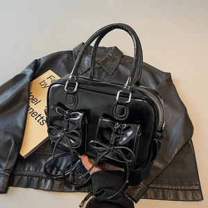 Elegant black patent leather square handbag with bows and contrast white stitching details