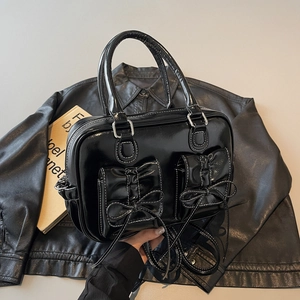 Retro black glossy leather handbag with bow pockets and white contrast stitching