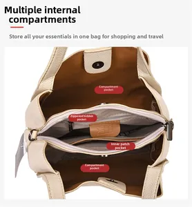 Interior view of off-white leather bucket bag showing compartments and zipper pocket