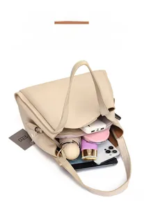 Top view of spacious cream tote bag showing organized storage of gadgets and makeup